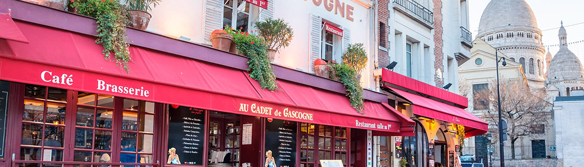 cafe montmartre with sacre coeur in background